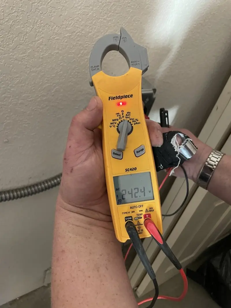 Voltage testing with clamp meter during Recessed Lighting Installation in Rock Falls